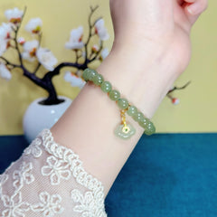 An 8mm Natural Hetian Jade Bracelet with a Nanhong Abacus-Style Beaded Design